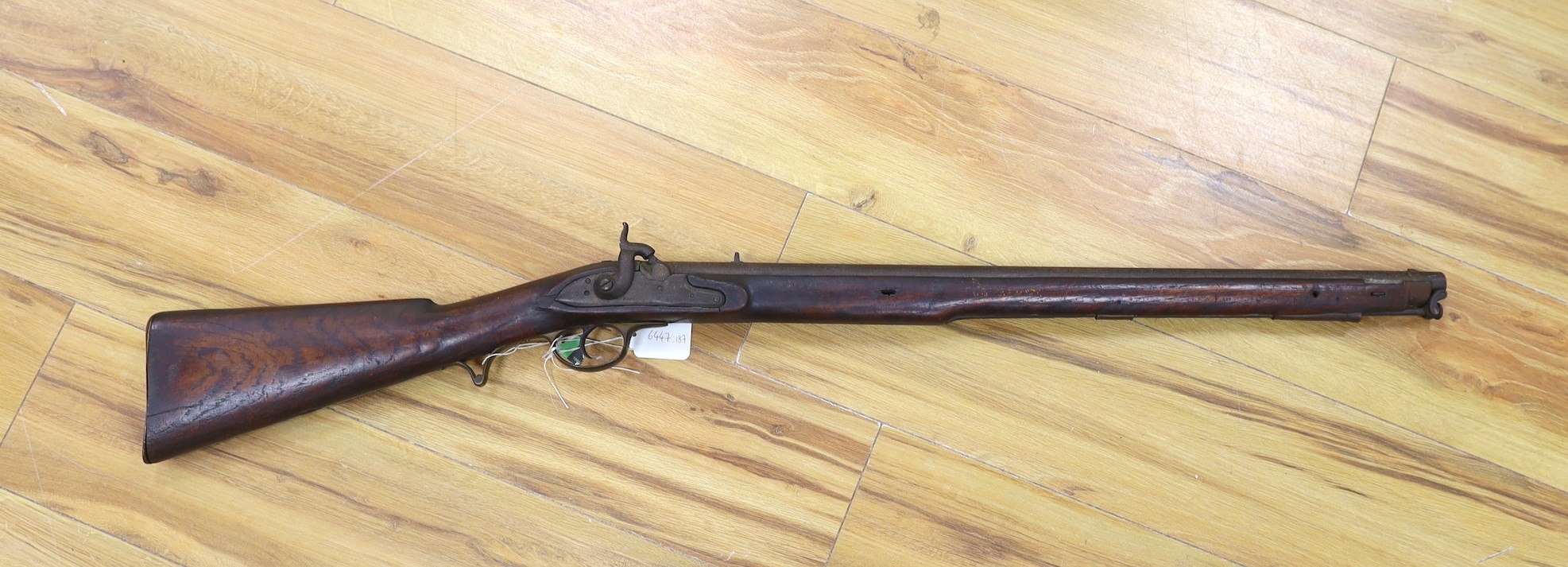A 19th century percussion musket, worn makers name to plate